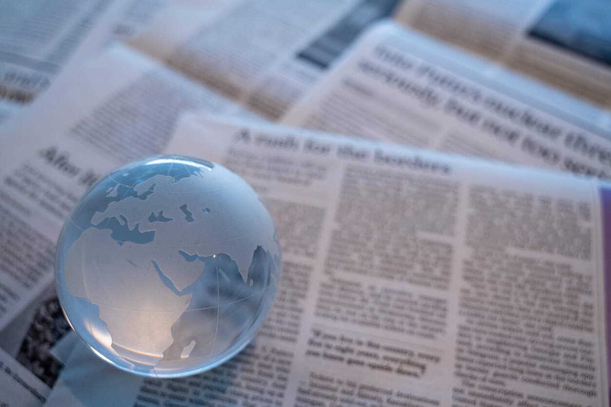 Glass globe on top of a newspaper.